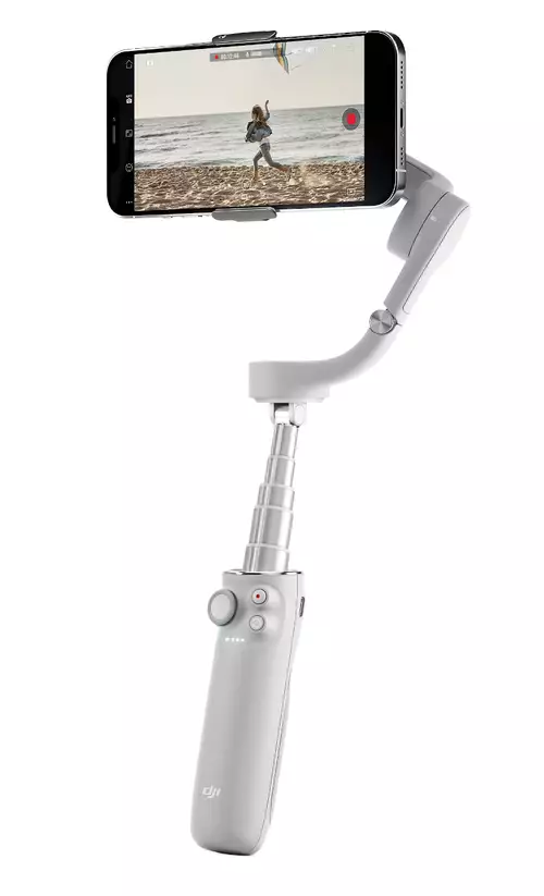 DJI OM5 with selfie stick extended.